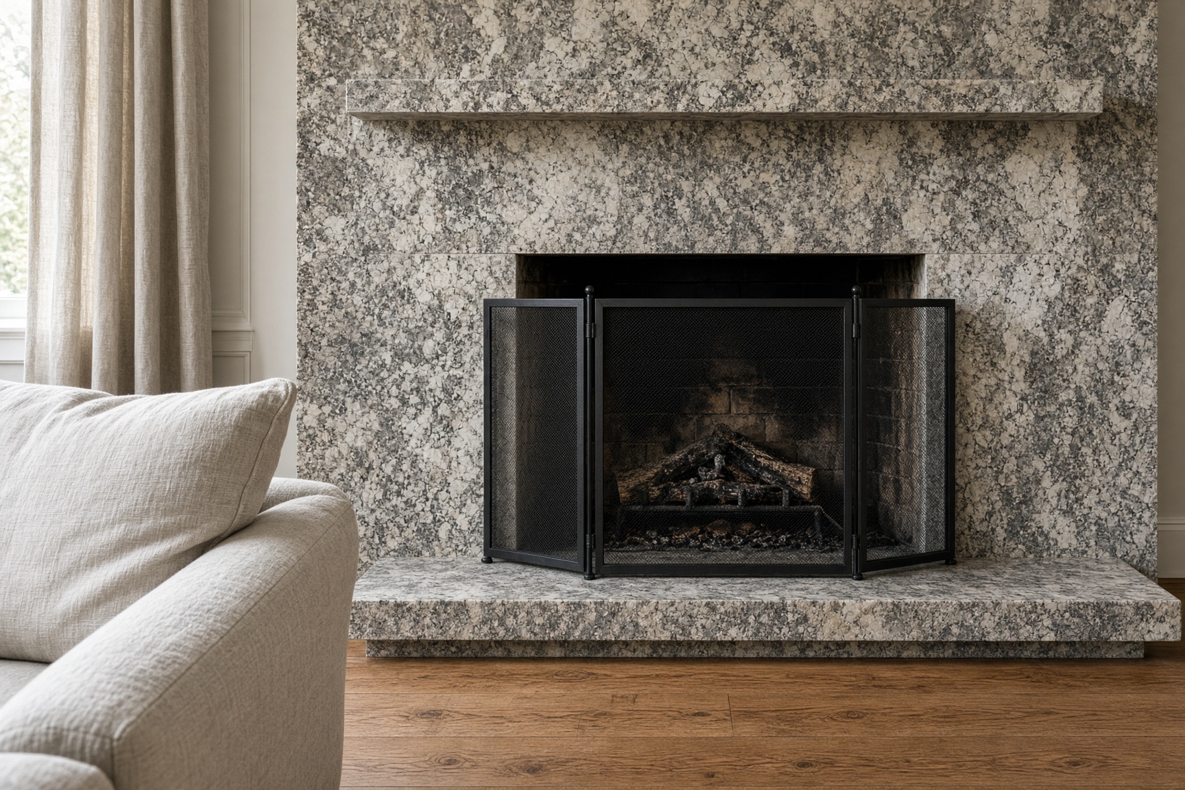 Floor-to-ceiling granite fireplace surround in a living room